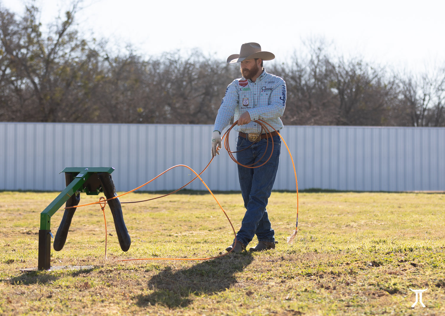 cowboy practicing roping skills with dummy steer outdoors