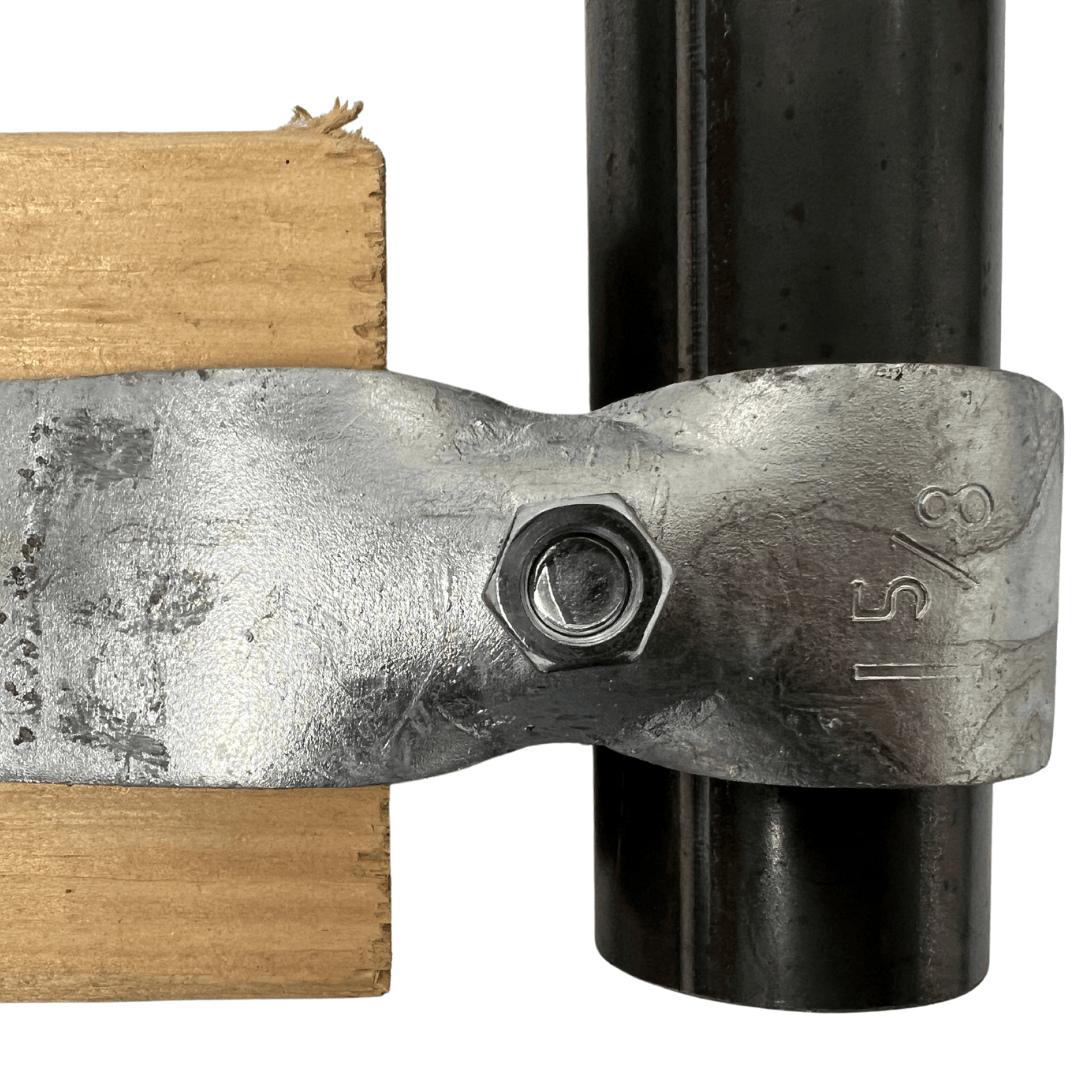 metal clamp with bolt securing wood and black pipe