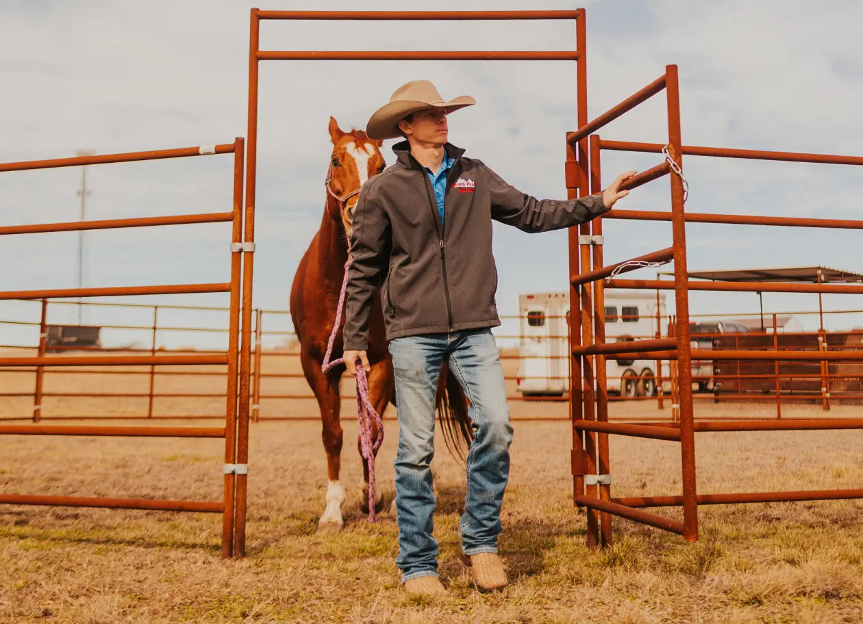 cowboy leading horse through gate ranch outdoor scene