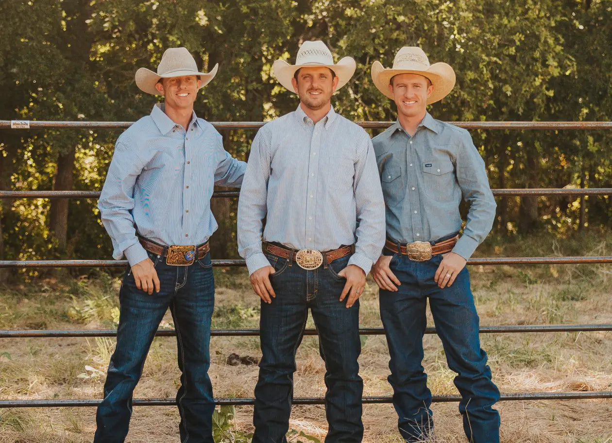 three cowboys wearing hats and jeans